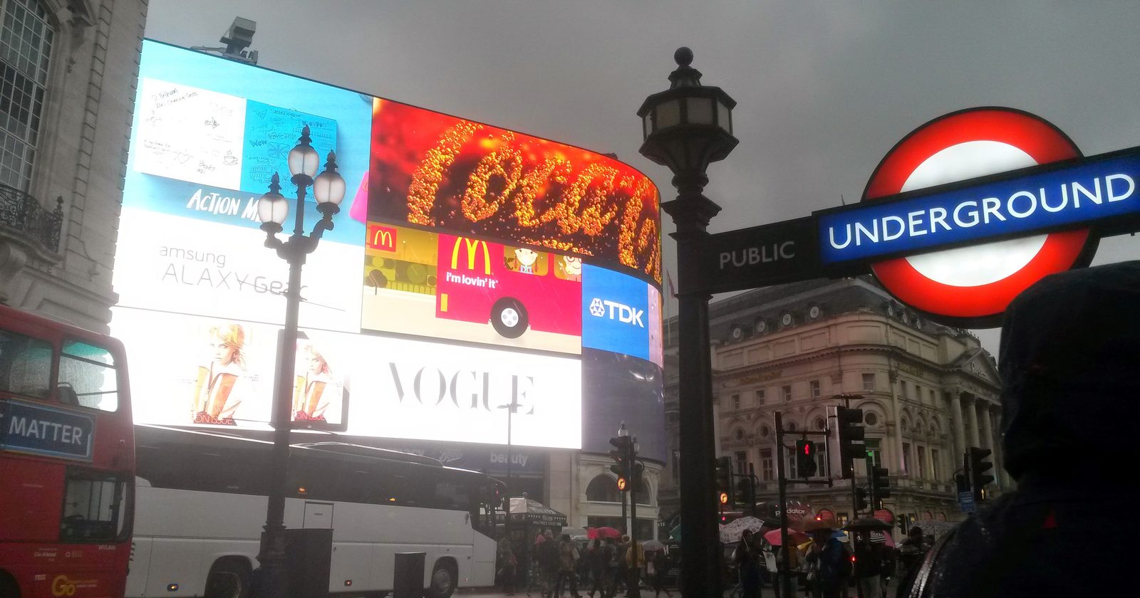 Wielkie podświetlane ekrany reklamowe nad ulicą przy Piccadilly Circus w Londynie